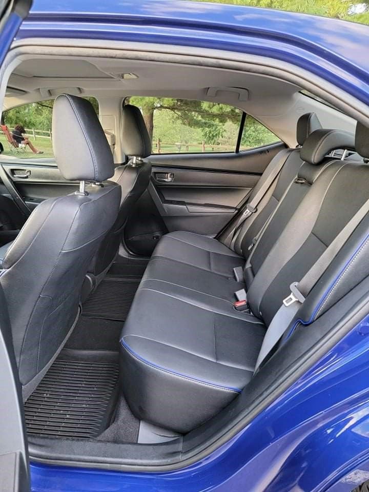 Blue sedan rear door open black leather seats